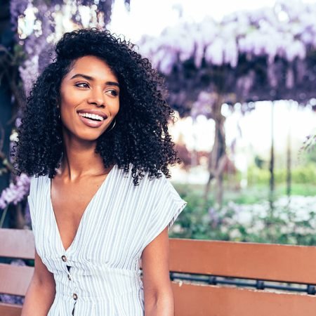 happy-young-black-woman-sitting-surrounded-by-LG4PBF3.jpg