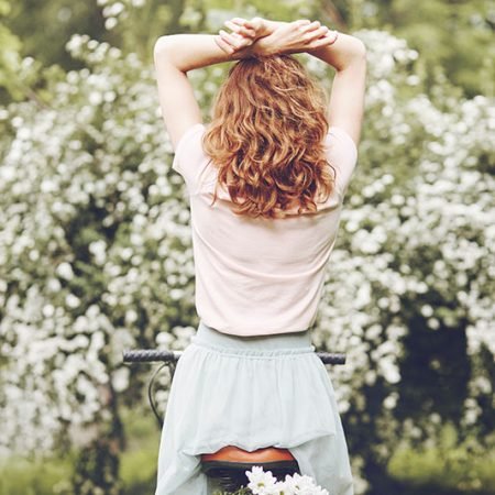 sensitive-woman-enjoying-the-flowers-5JLHAAR.jpg